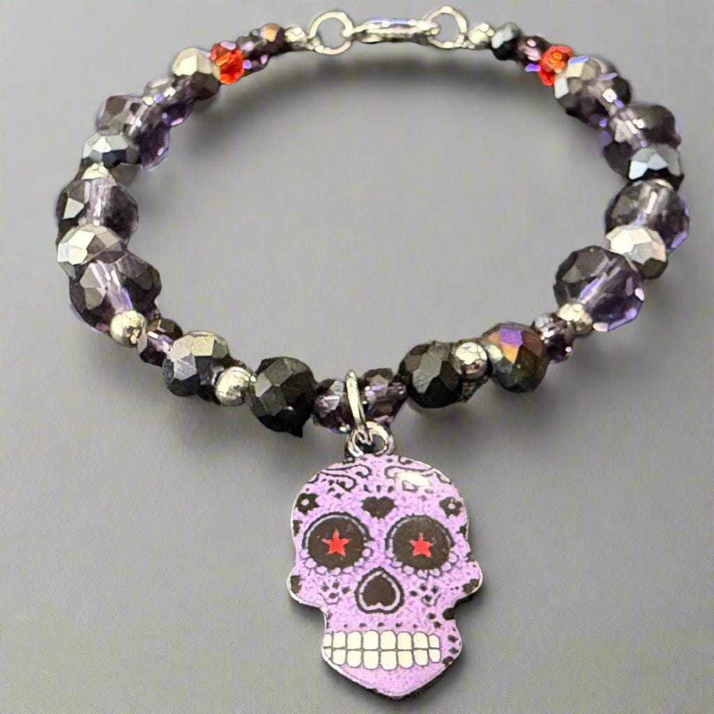 Beaded bracelet with a skull charm on a dark textured background