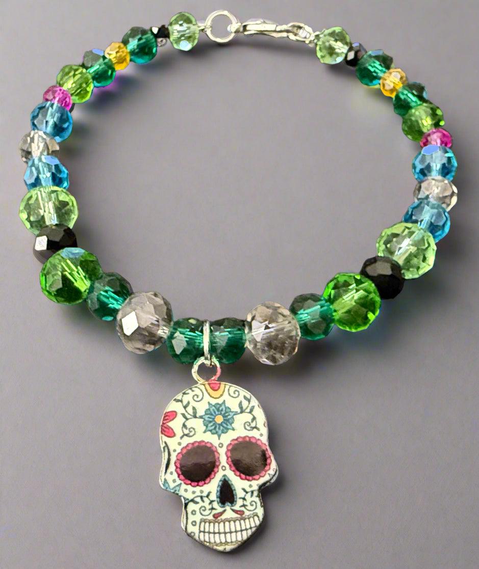 Colorful beaded bracelet with a skull charm on a dark background