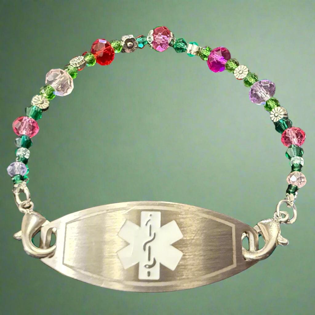 Multicolored beaded bracelet with a silver medical ID tag on a dark background