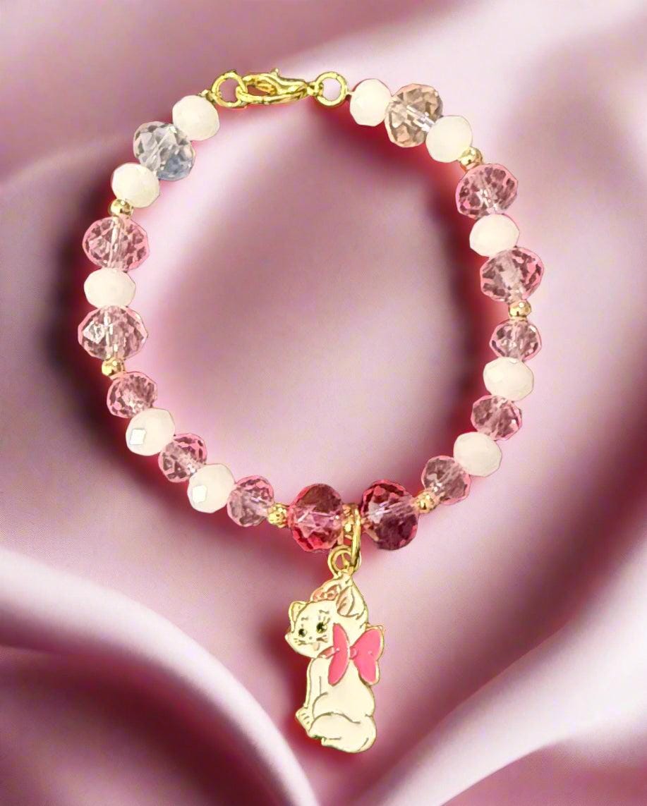 Beaded bracelet with pink and white beads on a dark background