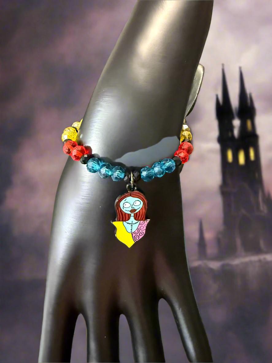 Colorful beaded bracelet with a unique charm on a black mannequin hand.