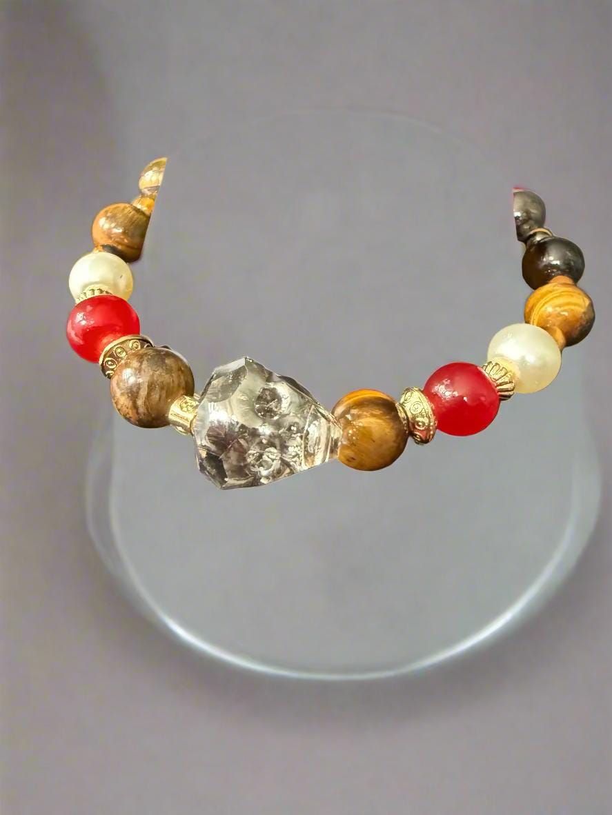 Beaded bracelet with multicolored beads on a black mannequin hand.