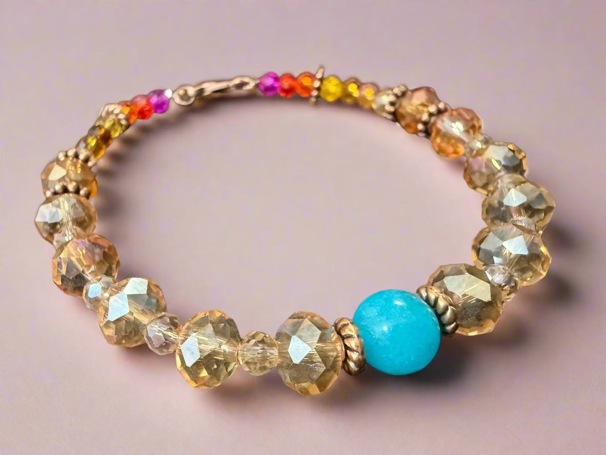 Beaded bracelet with multicolored beads and a turquoise stone on a black background