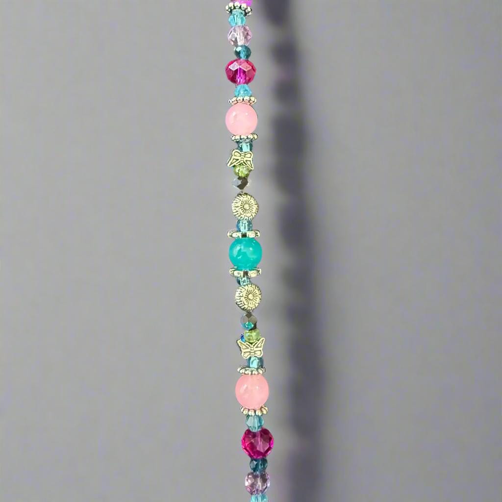 Multicolored beaded necklace on a dark textured background