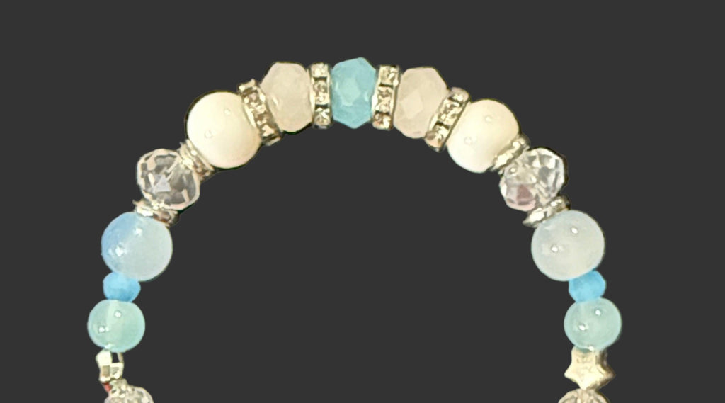 Beaded bracelet with blue and clear beads on a dark background