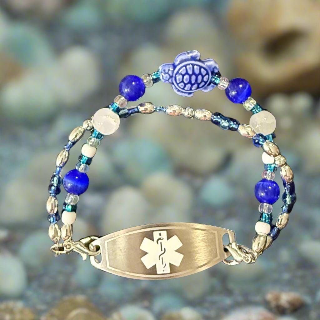 Beaded bracelet with an emergency medical symbol tag on a dark background