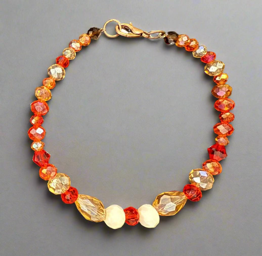 Beaded bracelet with gold clasp on a dark textured surface