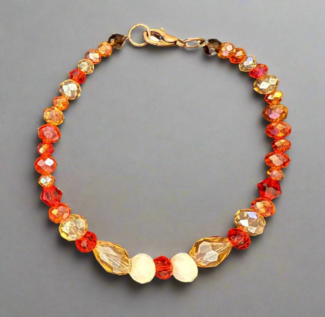 Beaded bracelet with gold clasp on a dark textured surface