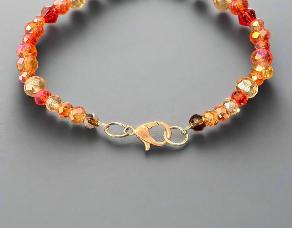 Beaded bracelet with multicolored beads on a dark textured surface