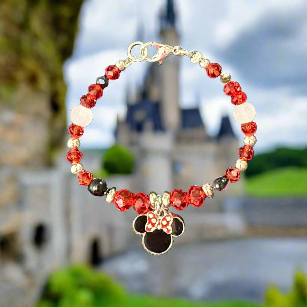 Beaded bracelet with floral charm on a textured gray surface