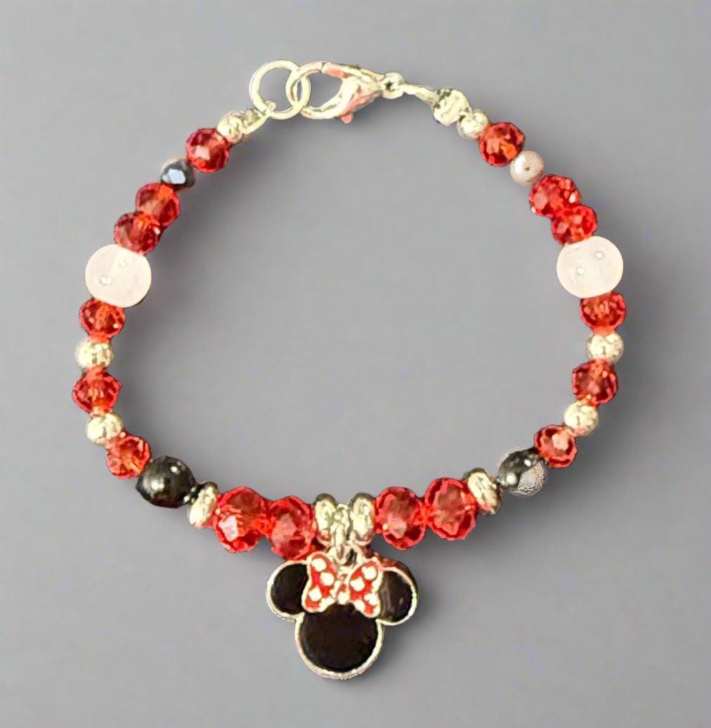 Beaded bracelet with a Minnie Mouse charm on a gray background