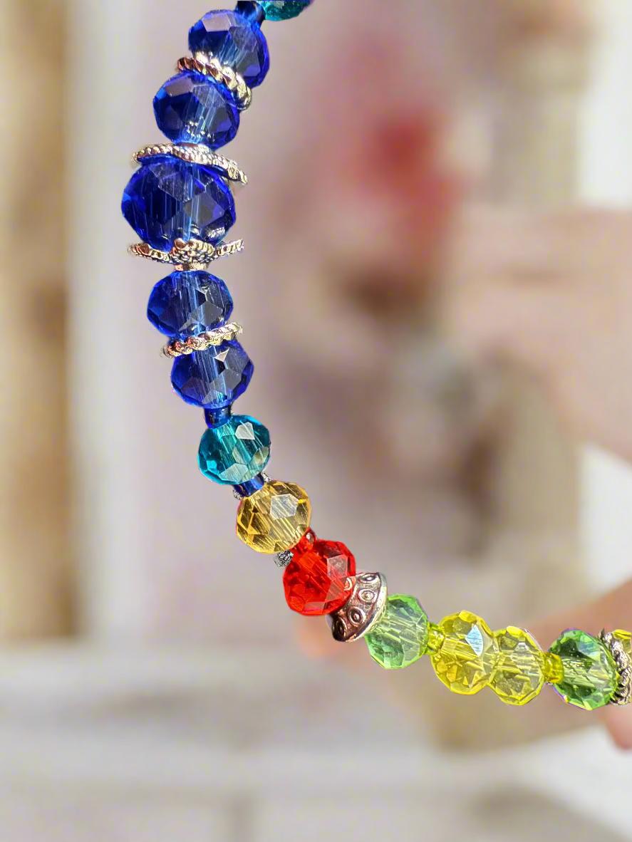 Colorful beaded bracelet on a dark textured surface