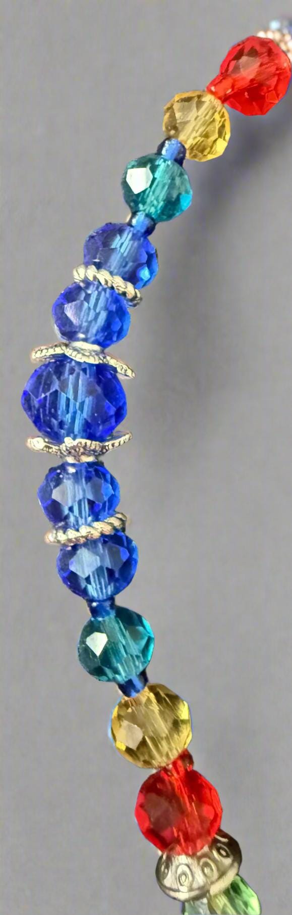 Colorful beaded bracelet on a textured dark surface