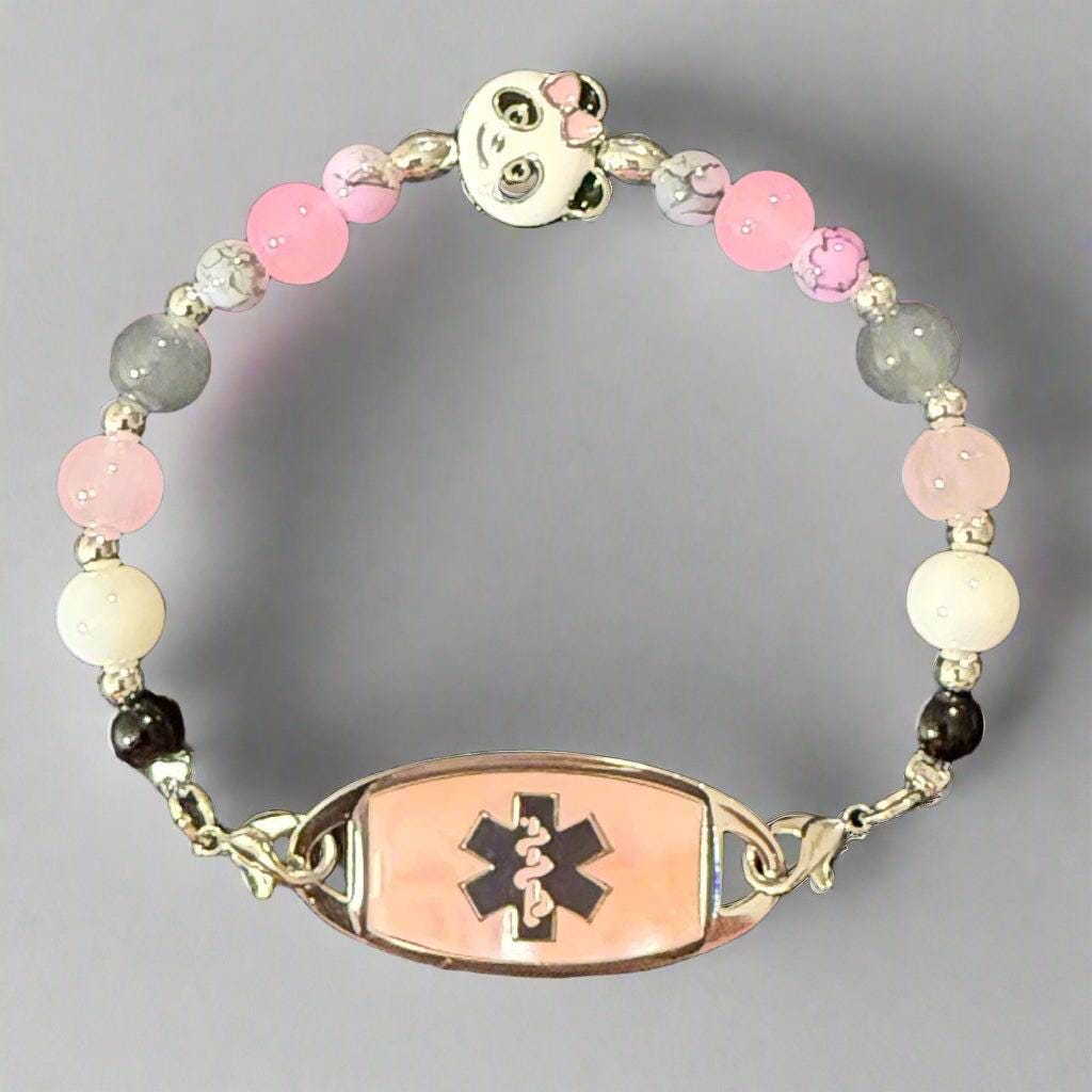 Beaded bracelet with medical symbol charm on a dark background