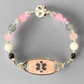 Beaded bracelet with medical symbol charm on a dark background