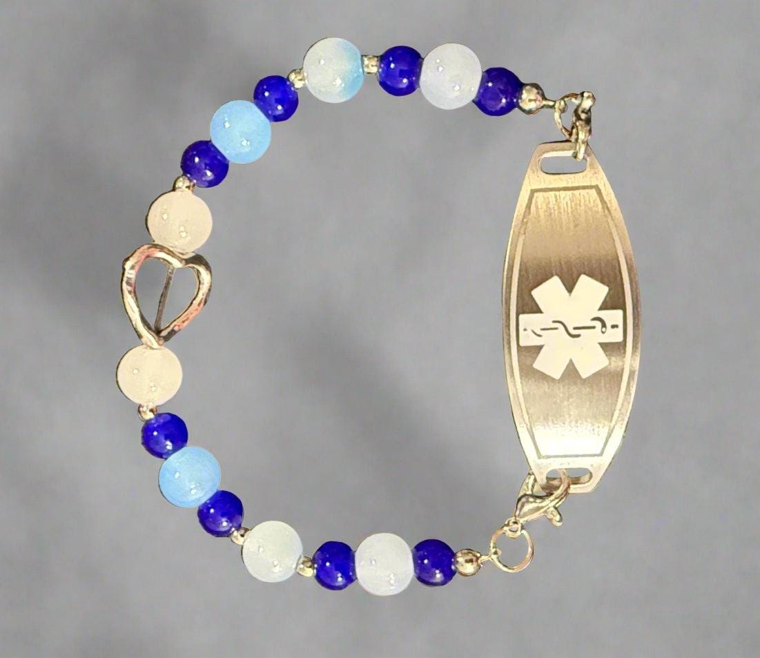 Bracelet with blue and white beads and a medical ID tag on a dark background