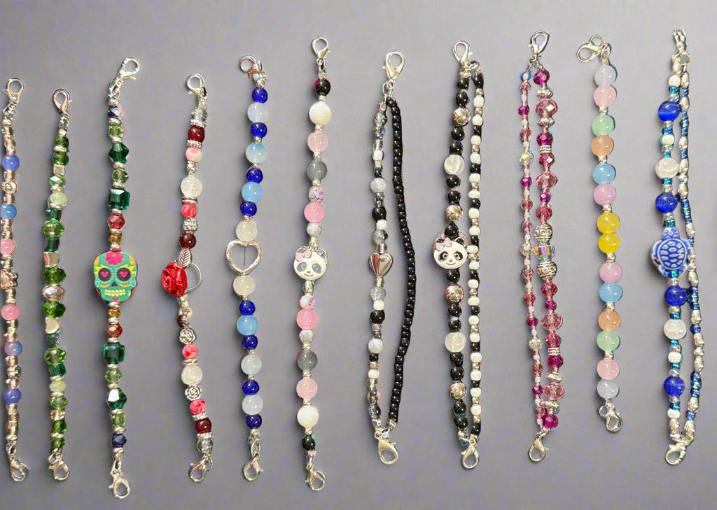 Collection of colorful beaded necklaces on a dark background