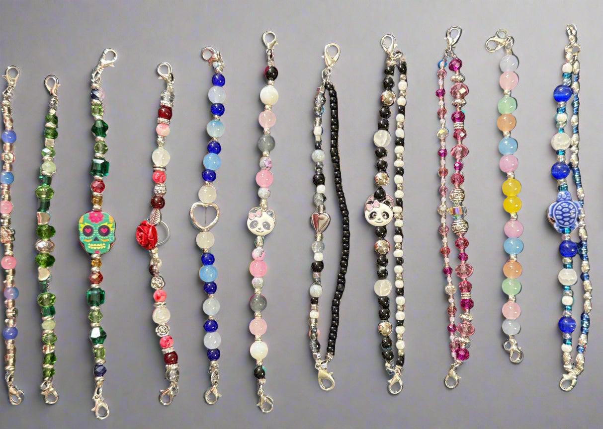 Collection of colorful beaded necklaces on a dark background