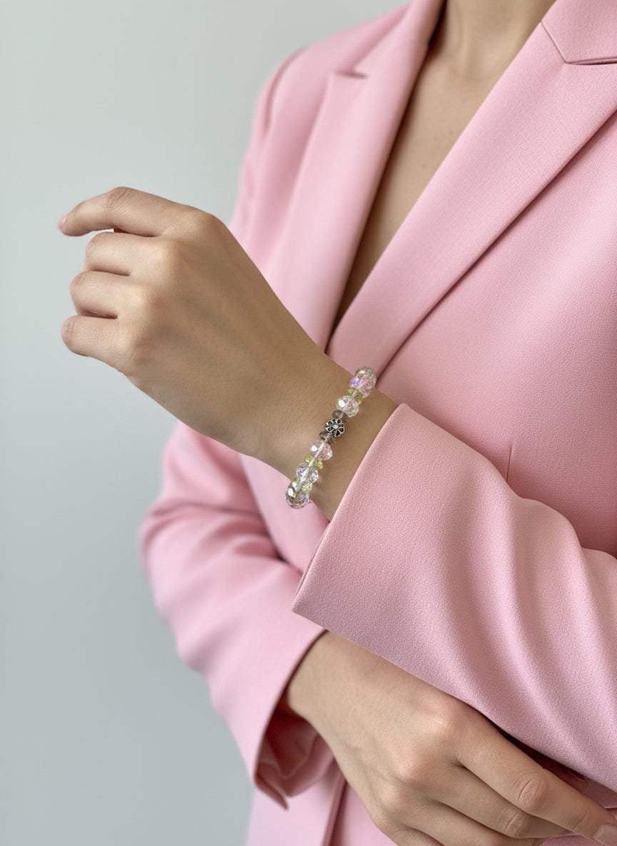 Beaded bracelet on a mannequin arm with a plain background