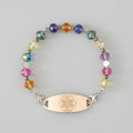Bracelet with colorful beads and a gold tag on a dark background