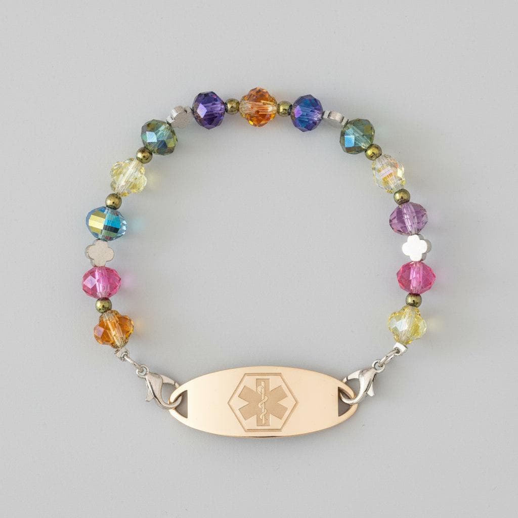 Bracelet with colorful beads and a gold tag on a dark background