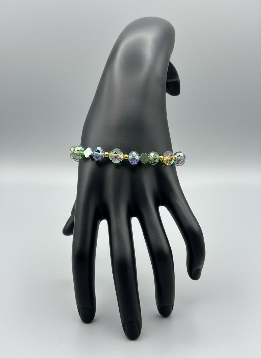 Multicolored beaded bracelet on a mannequin hand against a neutral background