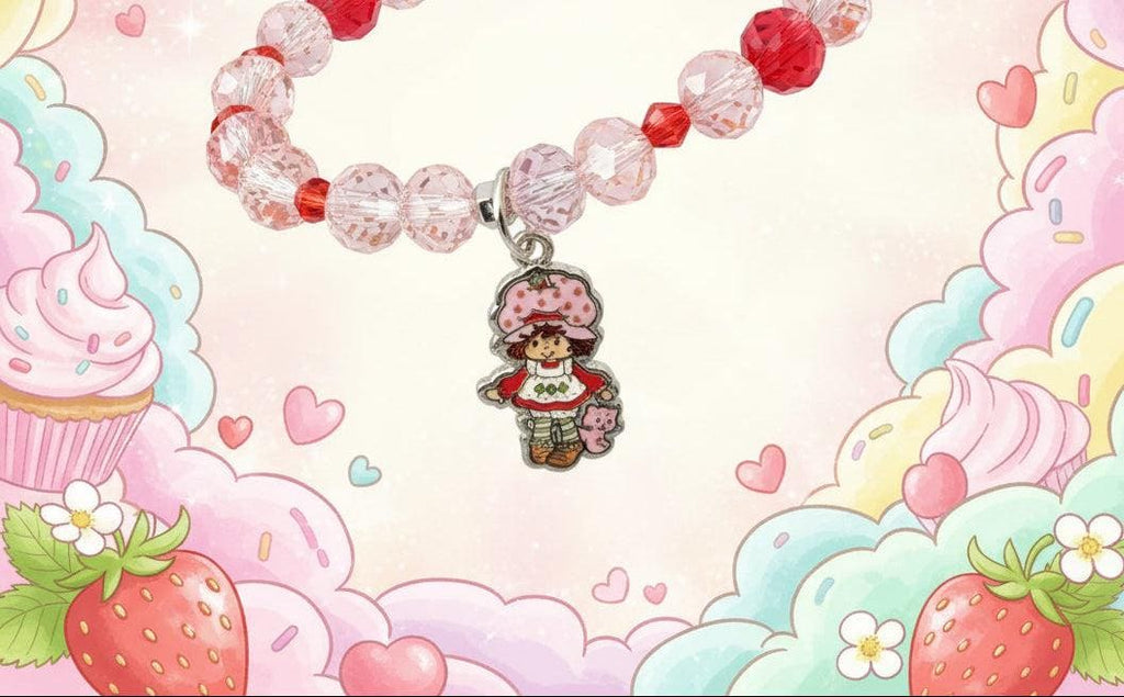 Bracelet with pink beads and a character charm on a mannequin hand.