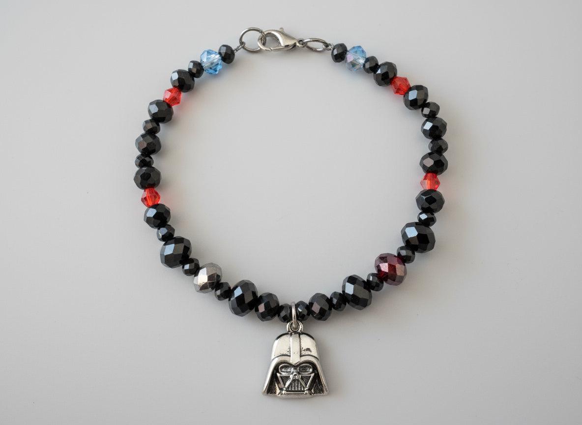 Beaded bracelet with a charm on a dark gray background