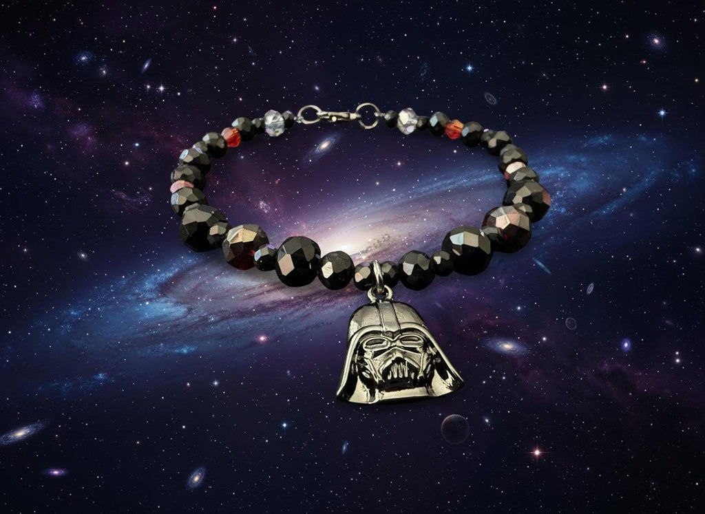 Bracelet with black beads and Darth Vader pendant on a dark textured background