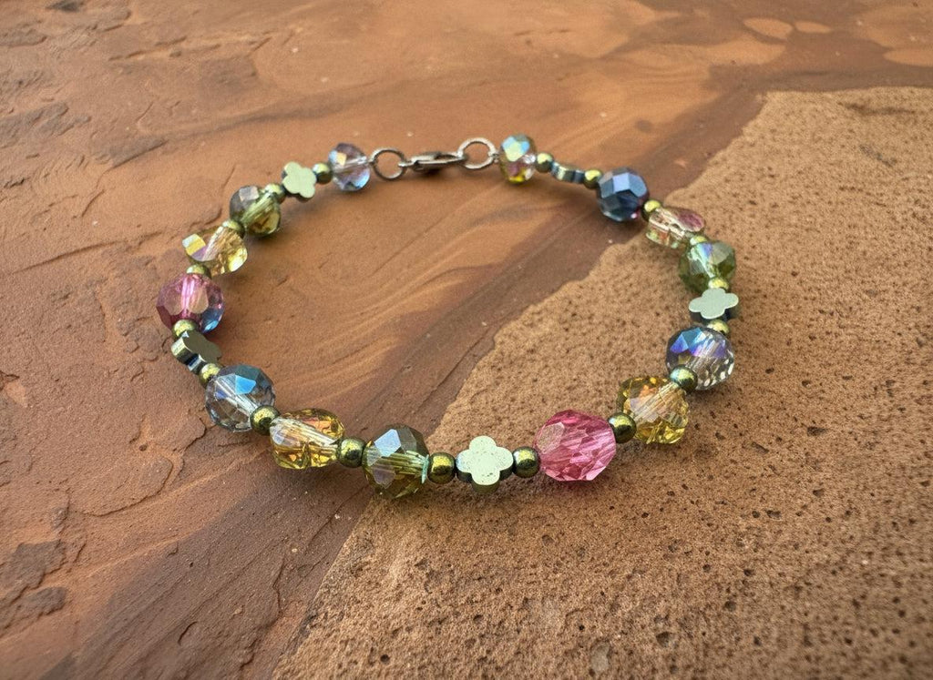 Multicolored beaded bracelet on a dark textured surface