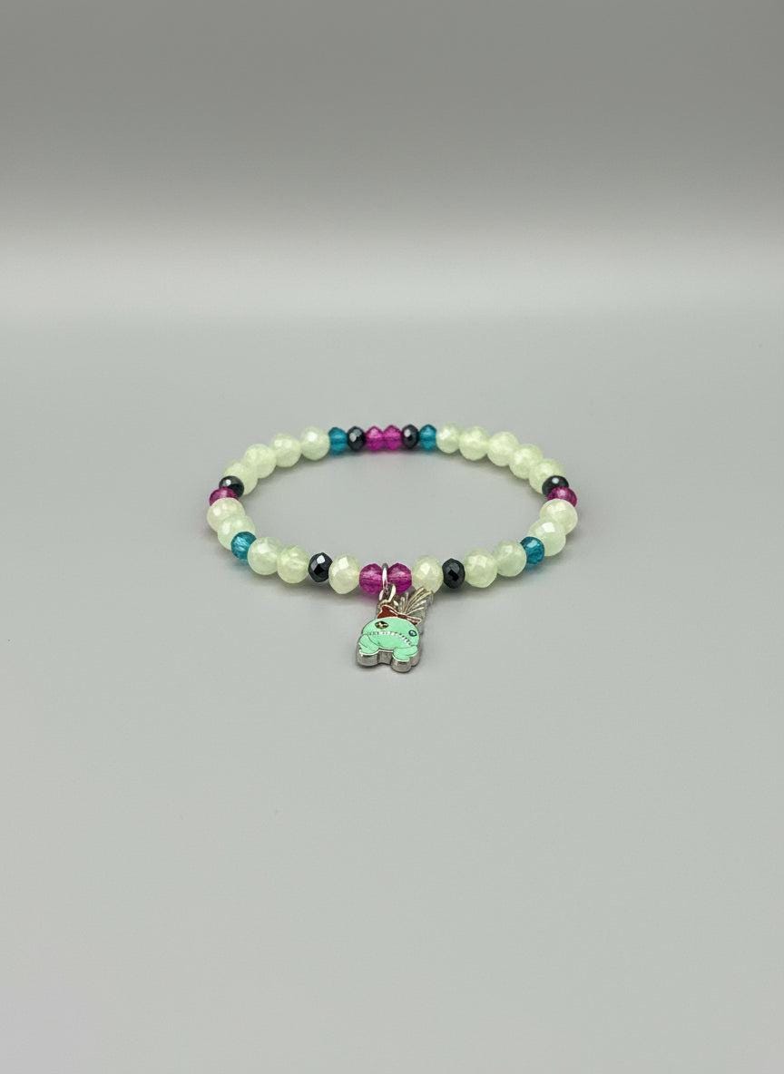 Colorful beaded bracelet with a charm on a car seat