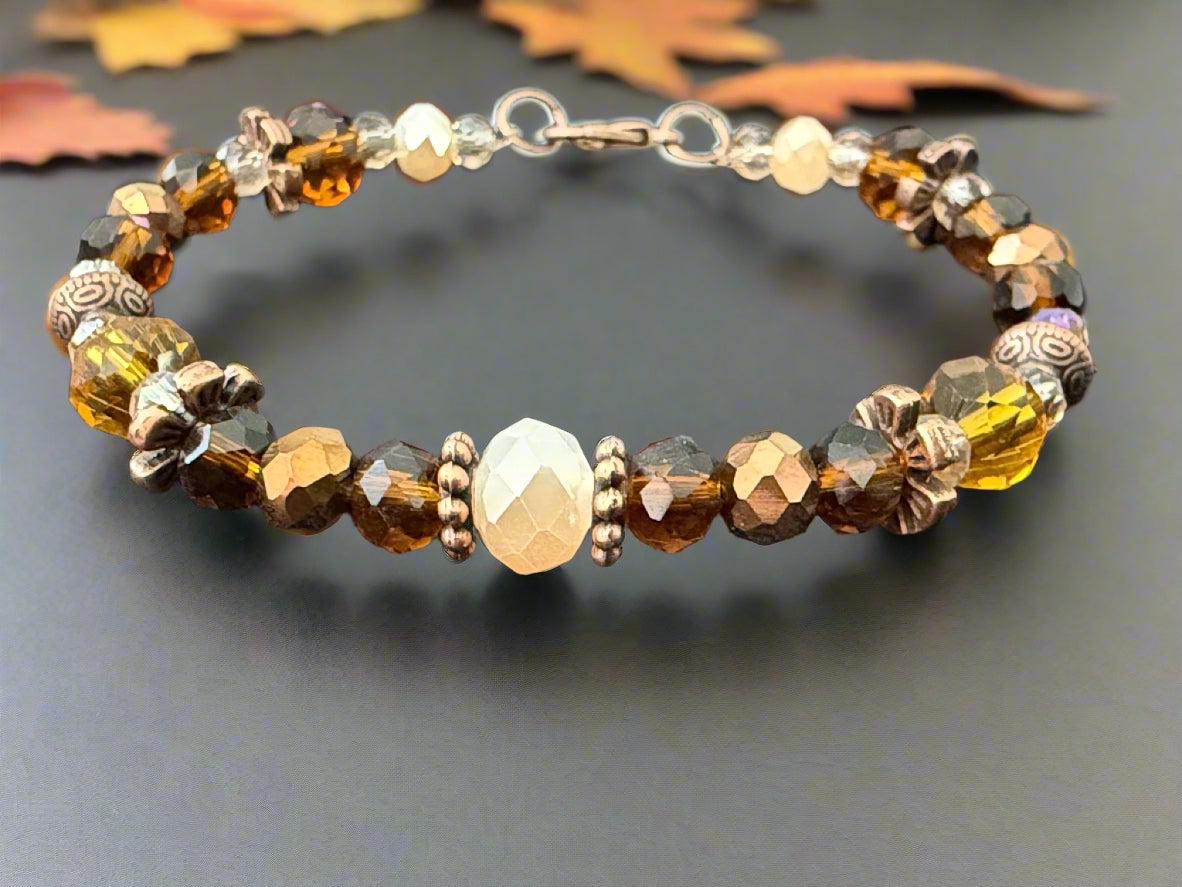 Beaded bracelet with gold and brown beads on a dark gray background