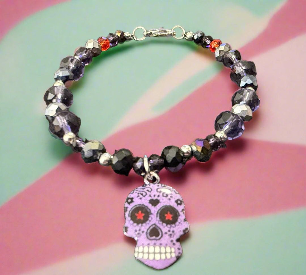 Beaded bracelet with a skull charm on a dark textured background