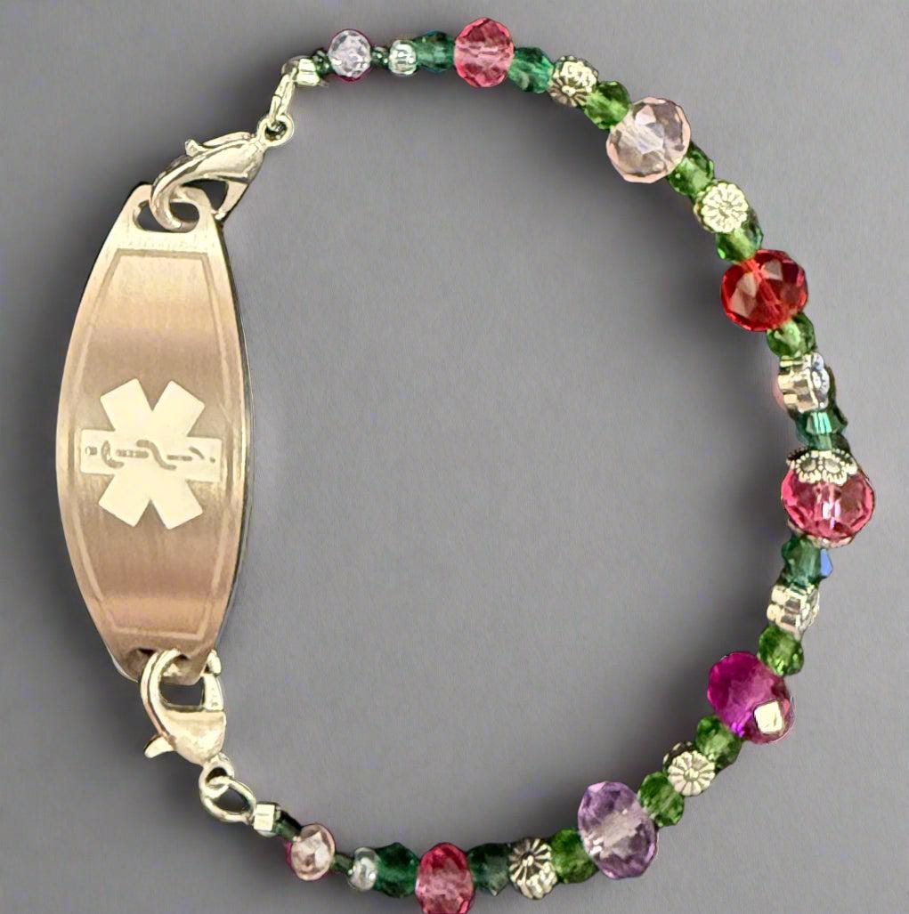 Multicolored beaded bracelet with an ID tag featuring a medical symbol on a dark background
