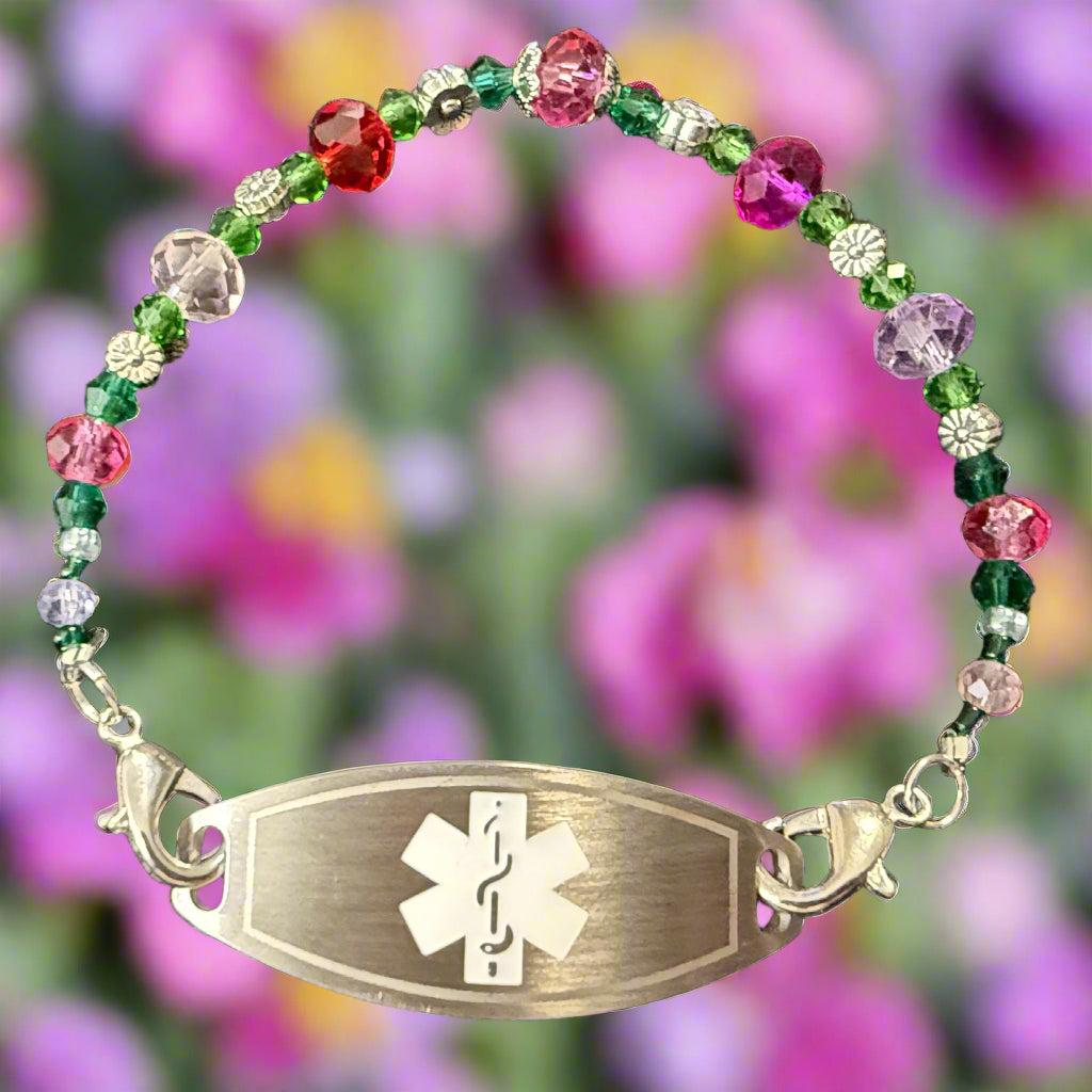 Multicolored beaded bracelet with a silver medical ID tag on a black background
