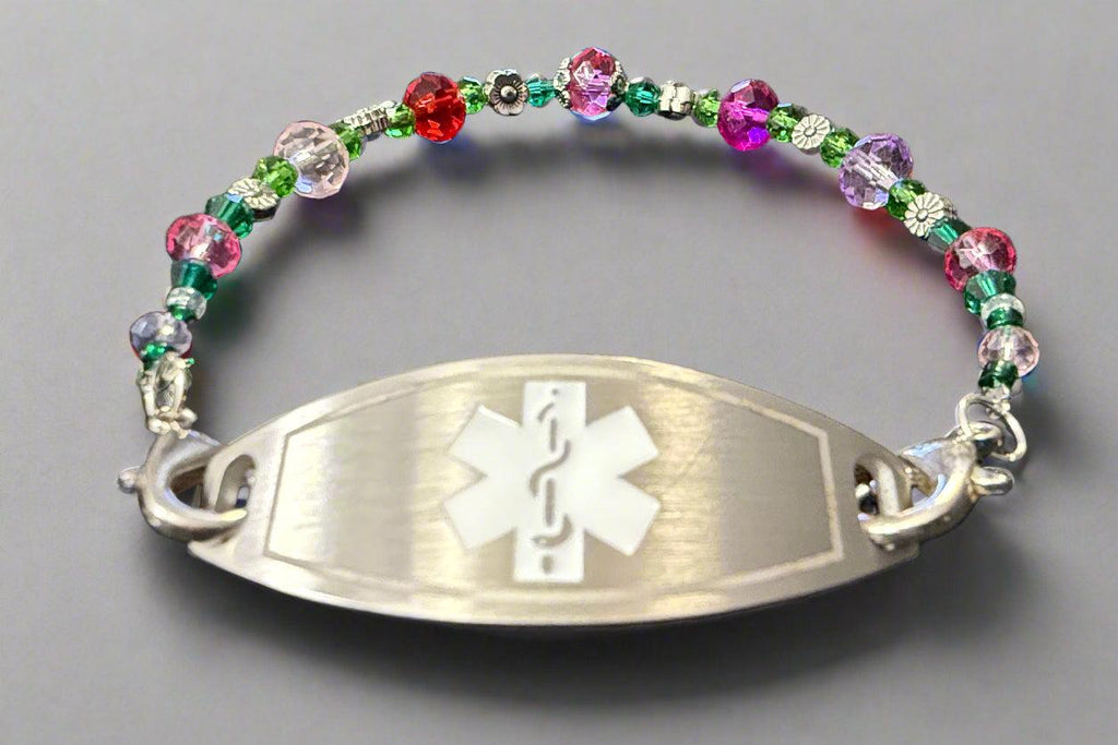 Multicolored beaded bracelet with a silver medical ID tag on a black background