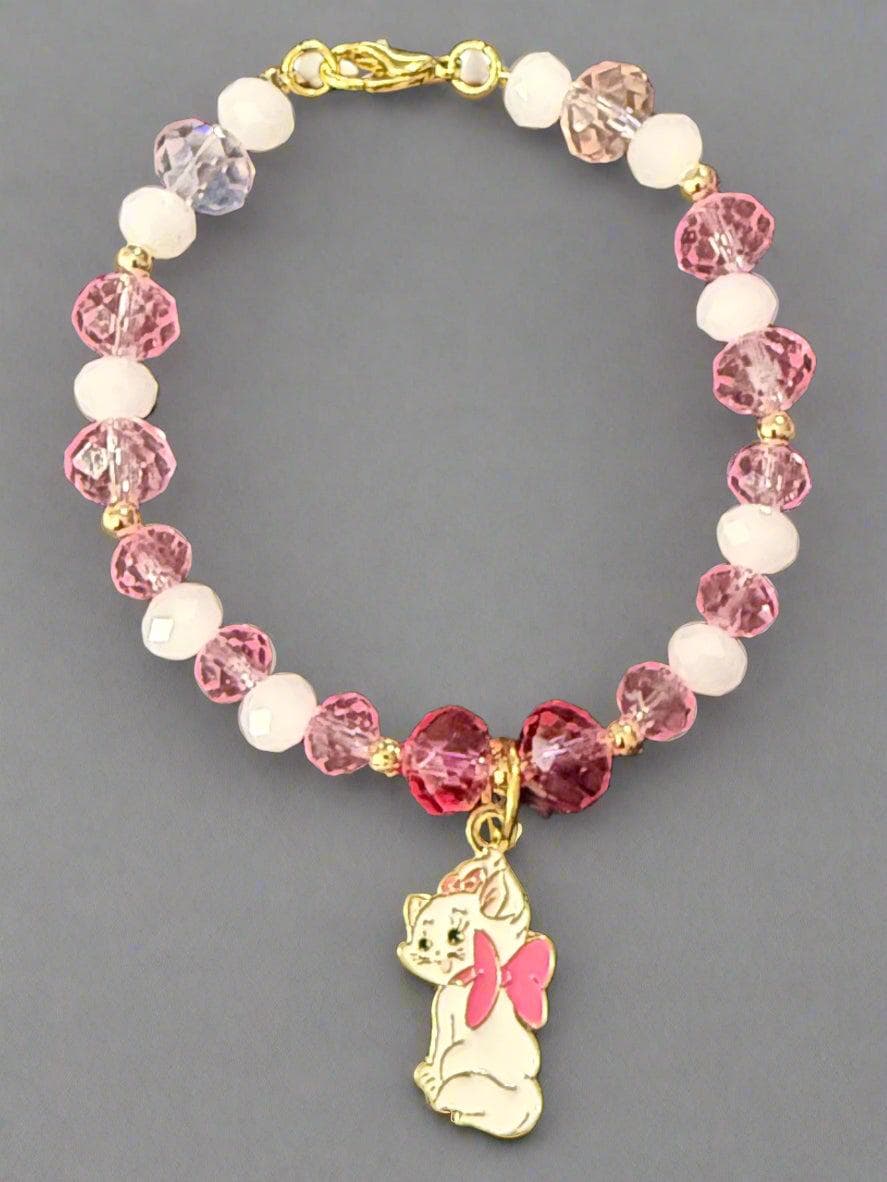 Beaded bracelet with pink and white beads on a dark textured surface