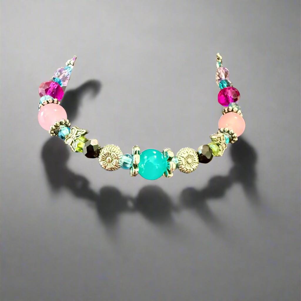 Colorful beaded bracelet on a mannequin hand with a blurred background