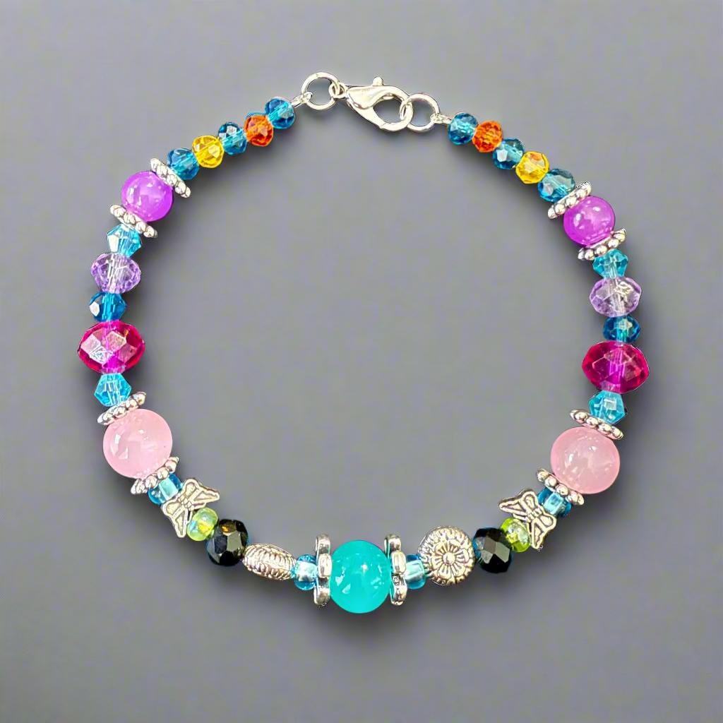 Colorful beaded bracelet on a gray textured background