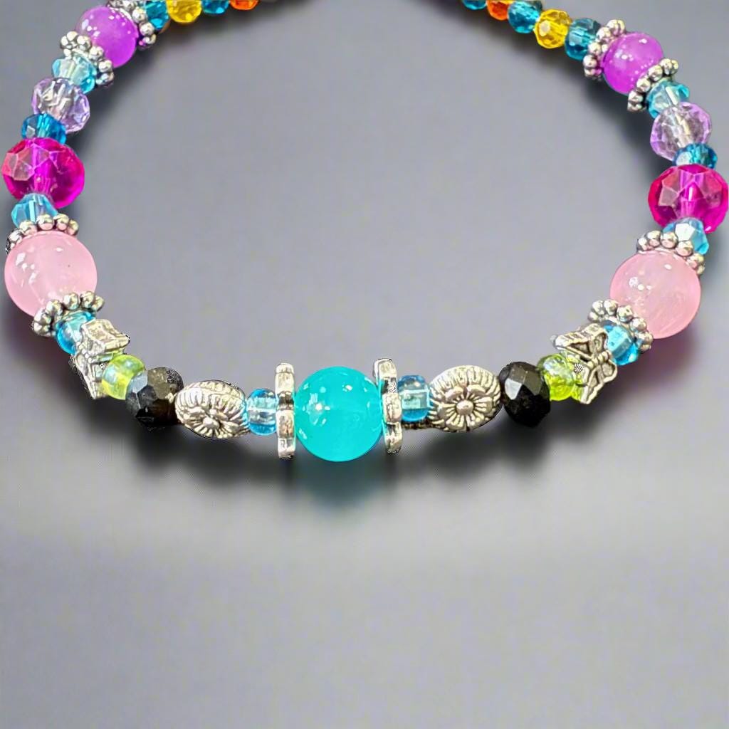 Colorful beaded bracelet on a gray textured surface