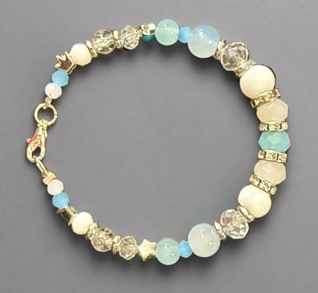 Beaded bracelet with white and blue beads on a dark background