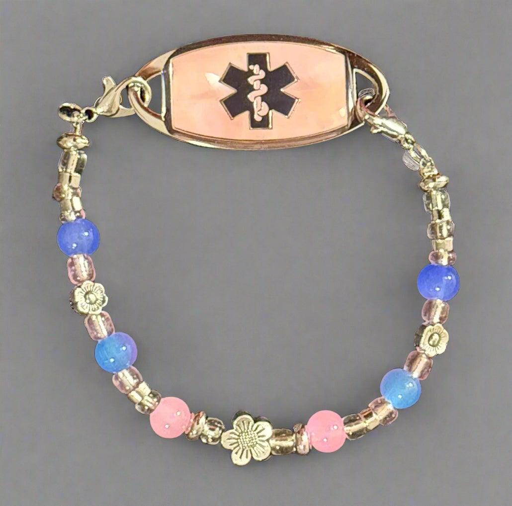 Beaded bracelet with medical alert emblem on a dark background