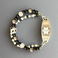 Beaded bracelet with panda charm and medical ID tag on a dark background