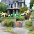 Multicolored beaded necklace on a textured gray surface