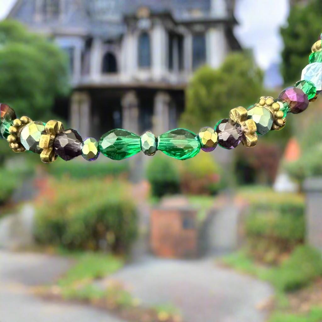 Multicolored beaded necklace on a textured gray surface