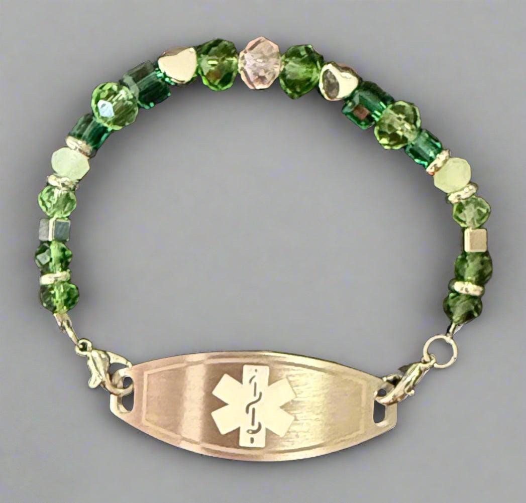 Green beaded bracelet with an emergency medical symbol on a black background